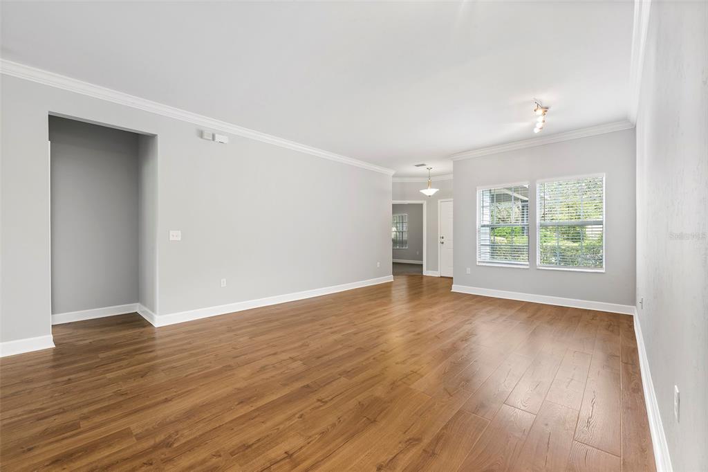 8376 Southwest 80th Place Gainesville, FL 32608 - Photo 6 of 37 an empty room with wooden floor and windows