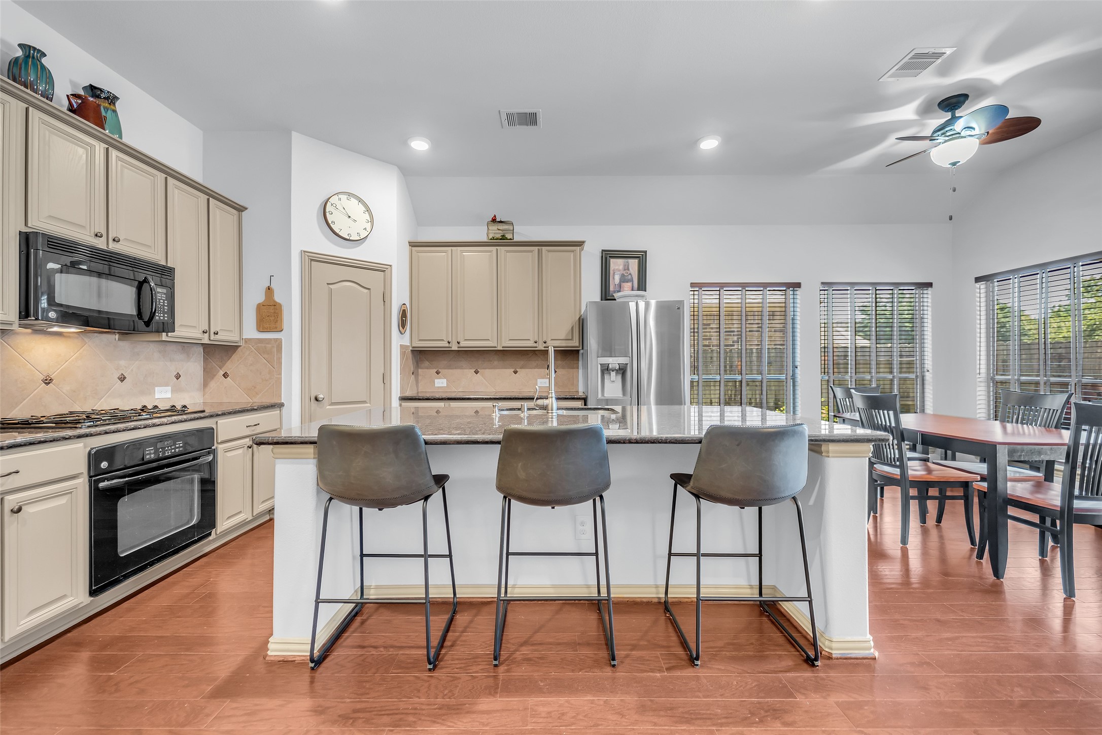 12006 Bayou Junction Road Cypress, TX 77433 - Photo 7 of 38 The kitchen is VERY large. Island plus breakfast nook offers lots of seating and dining options, aside from formal dining area. Countertop space, walk in pantry, gas cooktop roundout the features of this kitchen!