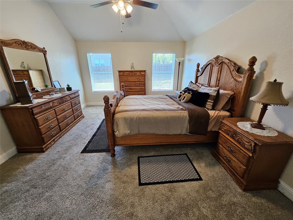 904 Avagail Avenue Springtown, TX 76082 - Photo 18 of 27 a bed room with a bed furniture and a fireplace