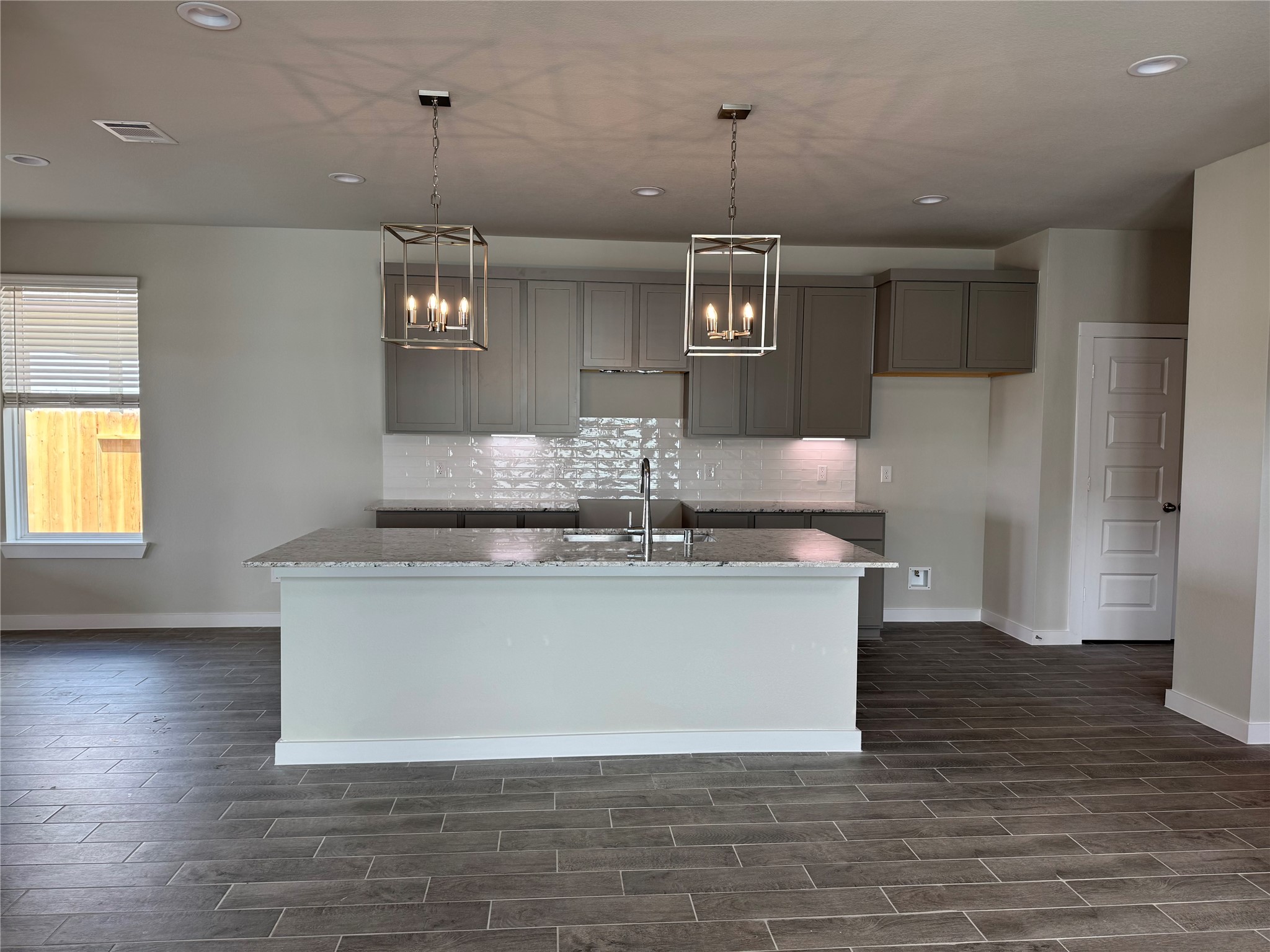 8738 Mallow Rose Way Rosharon, TX 77583 - Photo 3 of 16 a large kitchen with stainless steel appliances granite countertop a granite counter tops and a wooden floors