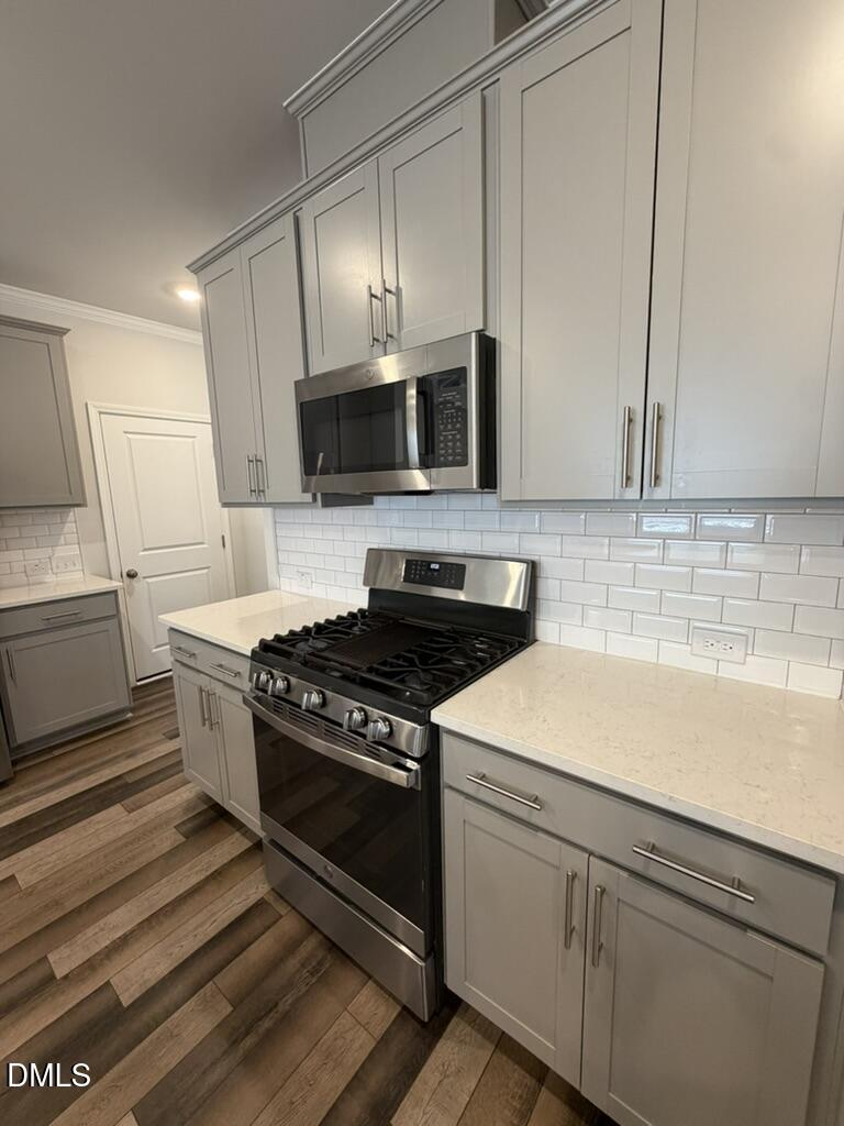 2509 Salt River Lane Raleigh, NC 27616 - Photo 12 of 34 a kitchen with stainless steel appliances white cabinets and stove top oven