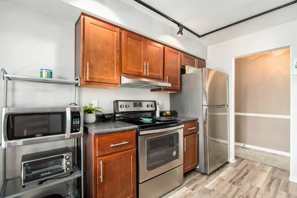 a kitchen with stainless steel appliances granite countertop a refrigerator stove and sink
