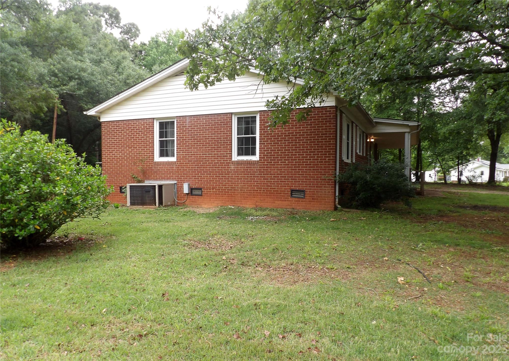 660 Faith Street Lancaster, SC 29720 - Photo 20 of 23 a backyard of a house with plants and large trees