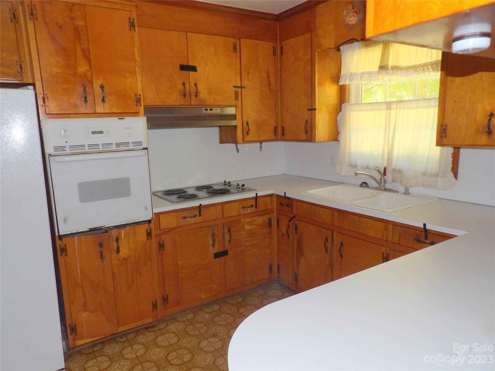 660 Faith Street Lancaster, SC 29720 - Photo 9 of 23 a kitchen with stainless steel appliances a sink cabinets and a window