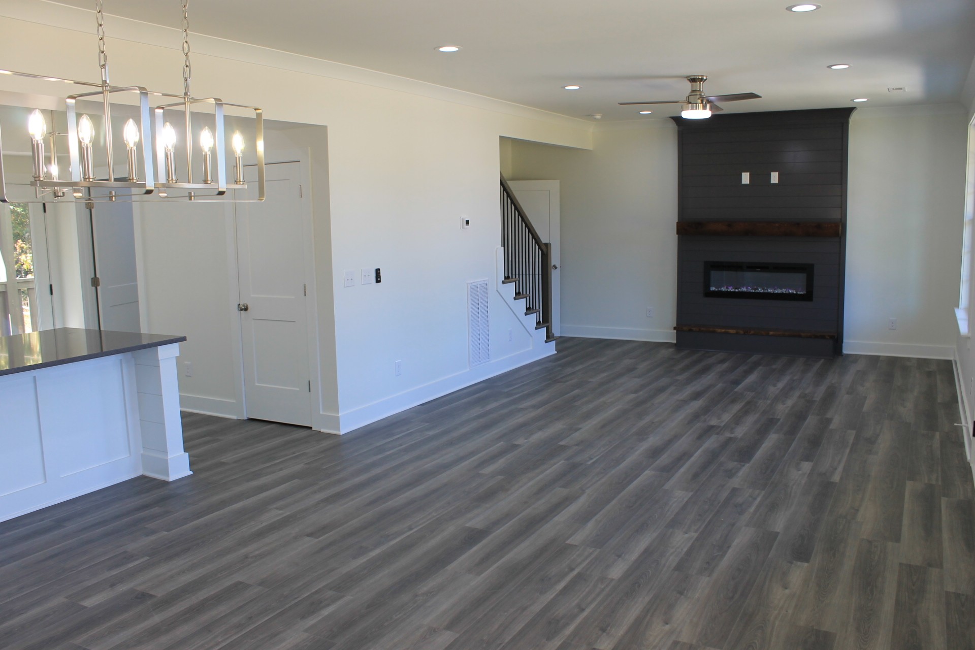 673 Shelton Road Manchester, TN 37355 - Photo 3 of 25 an empty room with wooden floor and staircase
