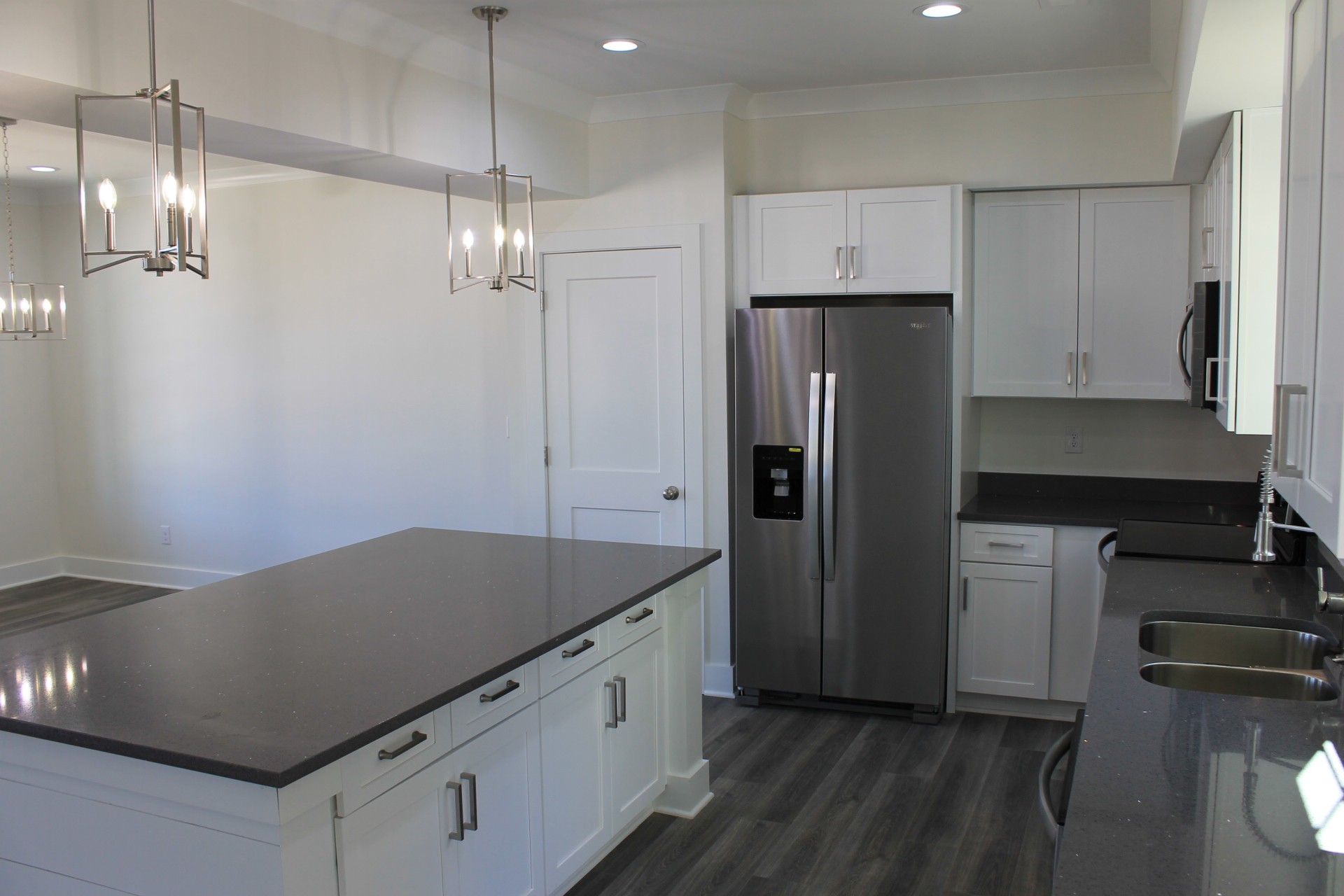 673 Shelton Road Manchester, TN 37355 - Photo 5 of 25 a kitchen with refrigerator cabinets and wooden floor
