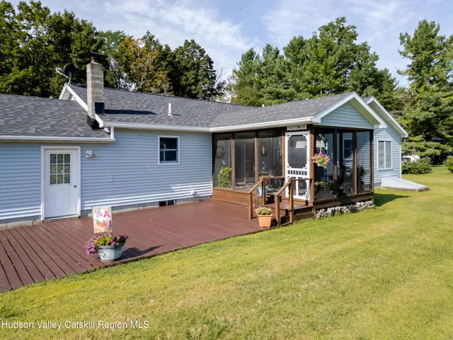 a view of a house with backyard porch and sitting area