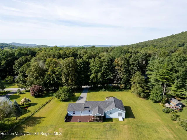 an aerial view of a house with a yard