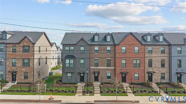 a front view of a residential apartment building with a yard