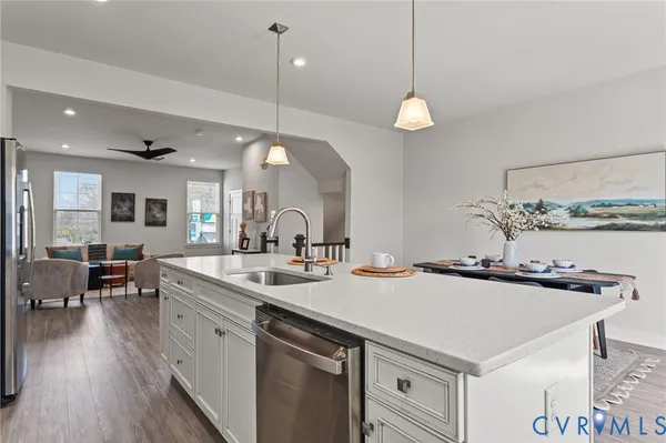 a kitchen with a sink a counter space and wooden floor