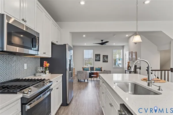 a kitchen with sink a stove and refrigerator