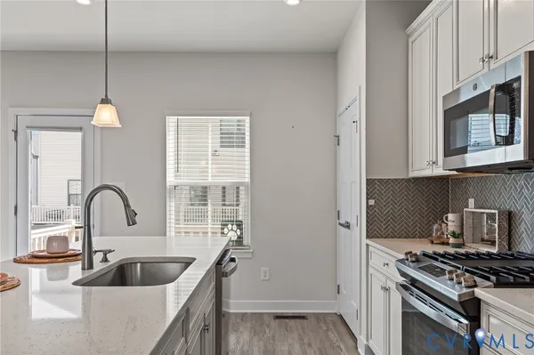 a kitchen with sink a stove and refrigerator