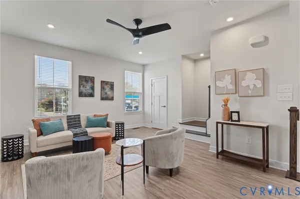 a living room with furniture and a wooden floor