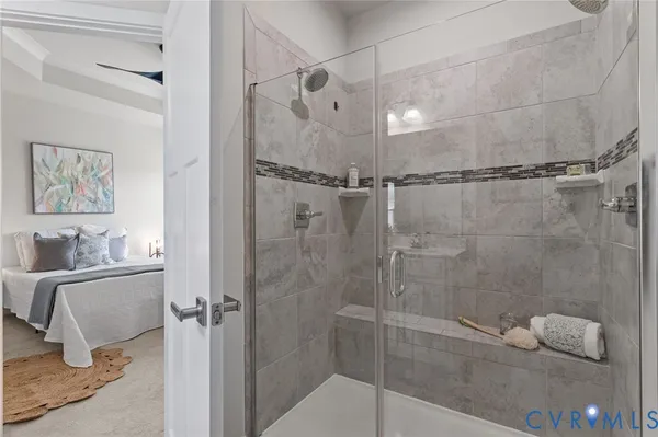 a bathroom with a granite countertop bathtub a toilet and a shower