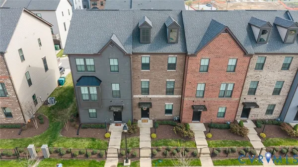 a view of a brick house next to a yard