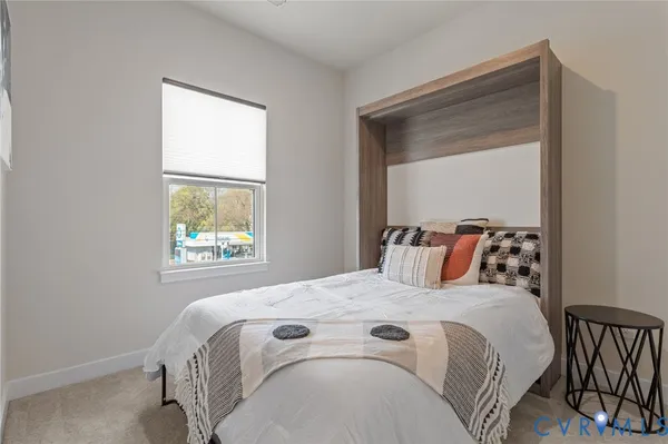 a bed sitting in a bedroom next to a window