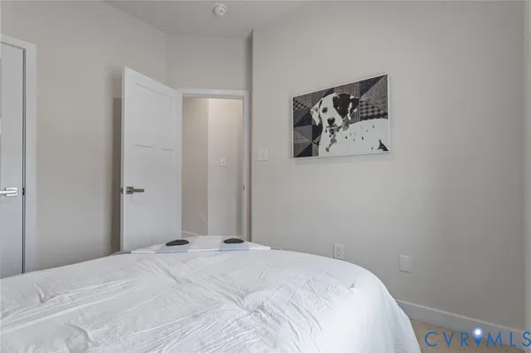 a bedroom with a bed and wall painting