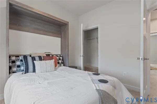 a bedroom with a large bed and a window