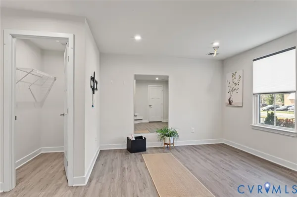 wooden floor in an empty room with a window