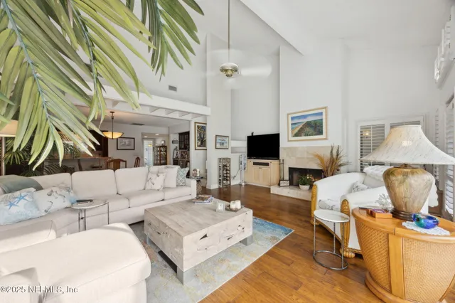 a spacious bedroom with a bed and a flat tv screen on dresser