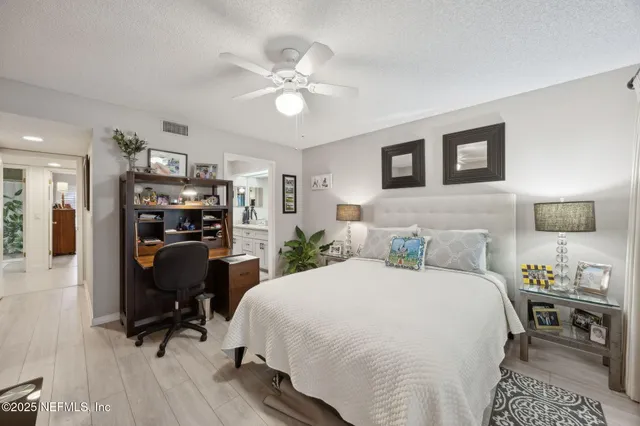 a view of a dining room with furniture a chandelier and a rug