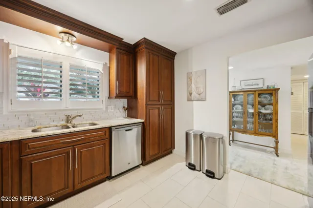 a kitchen with a sink and wooden floor
