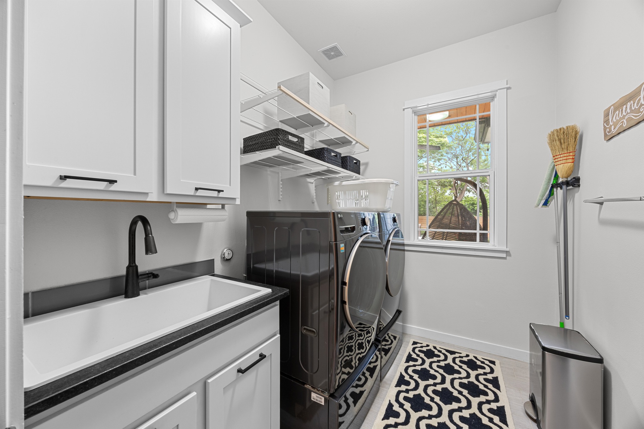 3907 Becker Avenue Austin, TX 78751 - Photo 14 of 33 Laundry room with sink, shelving, and more storage.
