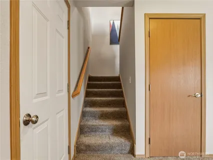 a view of a hallway with wooden floor and entryway