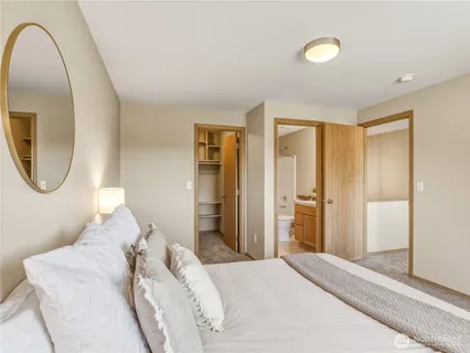 a bedroom with a bed and a mirror