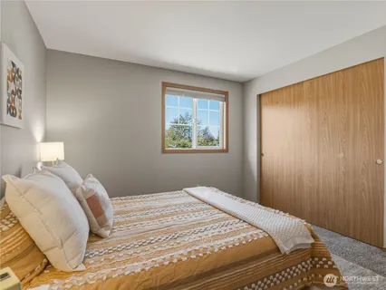 a bedroom with a bed and a window