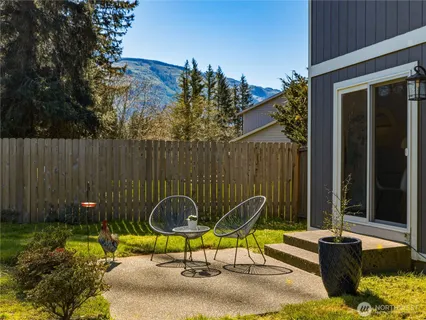 a view of a chairs and table in the backyard