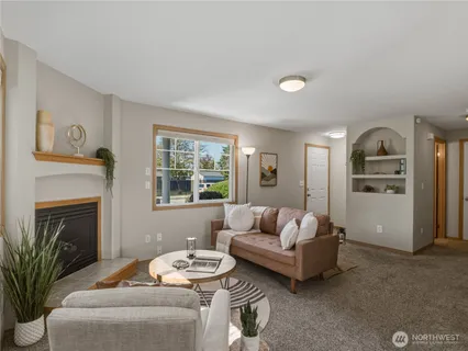 a living room with furniture and a fireplace