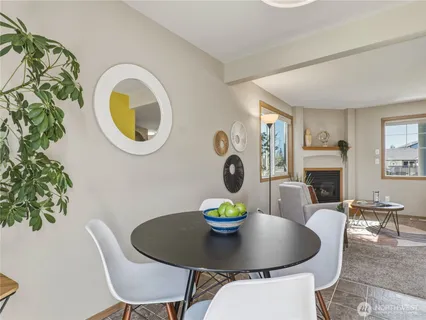a dining room with furniture a potted plant and a fireplace