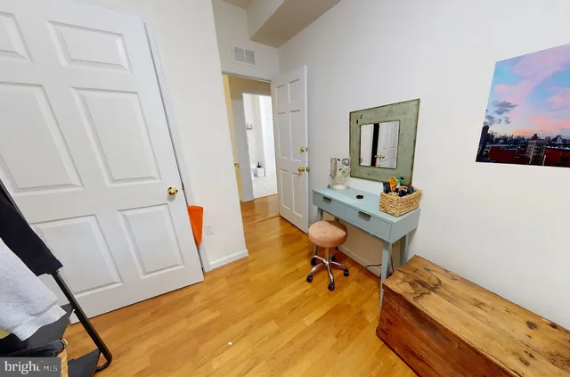 a room with wooden floor and furniture