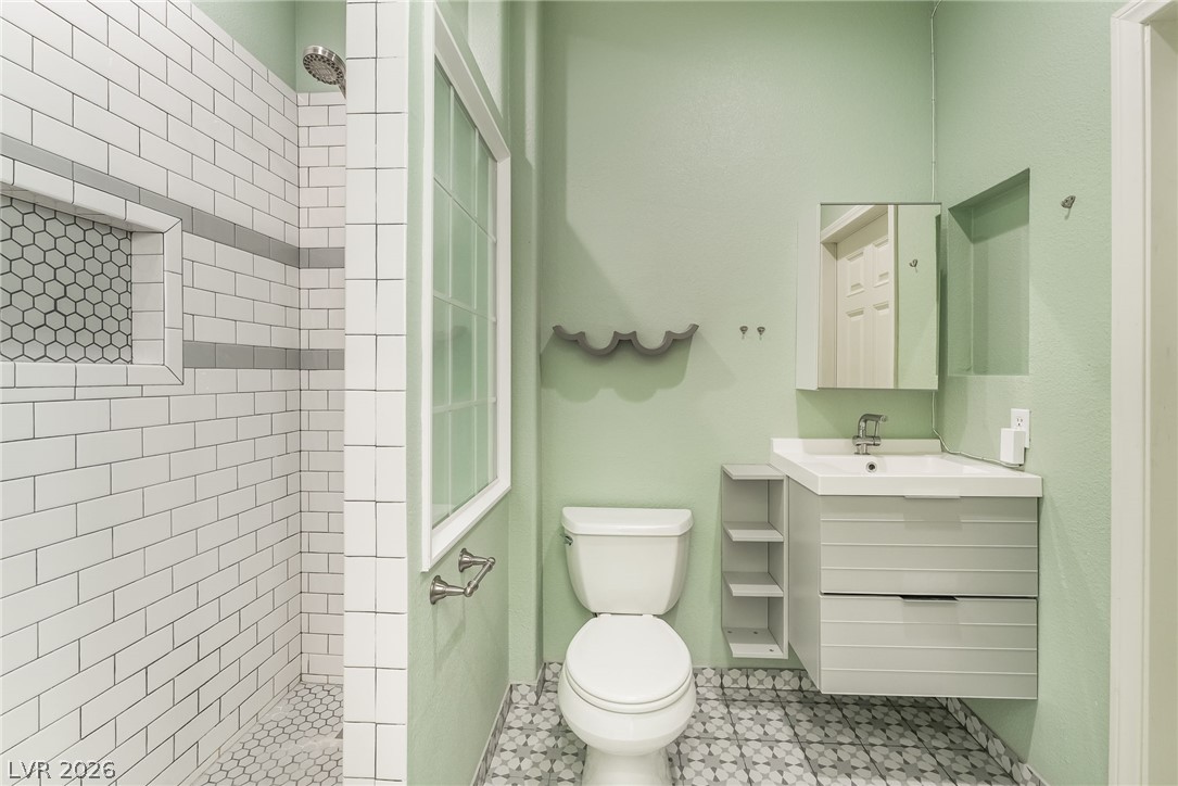 261 Timber Hollow Street Henderson, NV 89012 - Photo 22 of 51 A well-appointed bath features a tiled walk-in shower and a modern floating vanity.