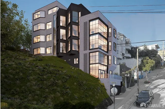 a view of a brick building next to a yard