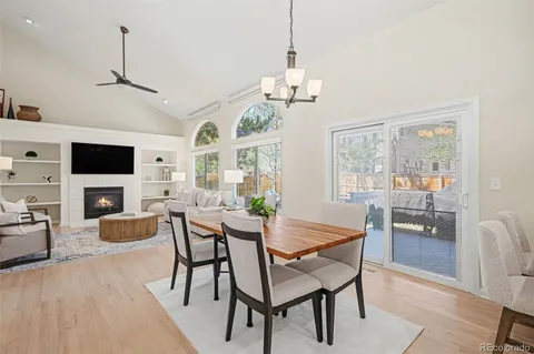 a view of a dining room with furniture a chandelier and wooden floor