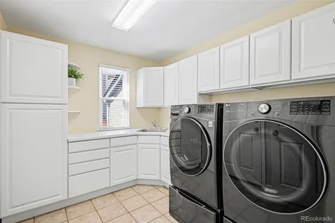 a utility room with sink dryer and washer