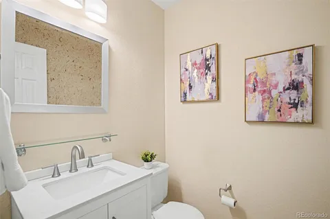 a bathroom with a toilet a sink and a mirror