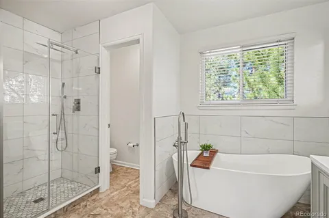 a bath tub sitting next to a shower
