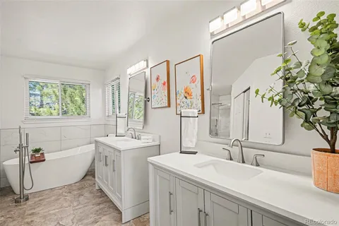 a bathroom with a sink and mirror with bathtub