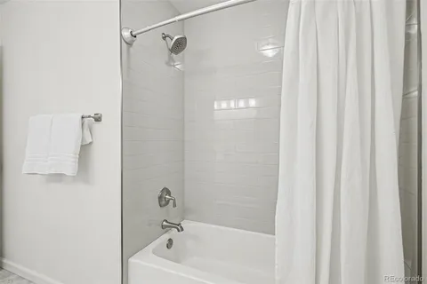 a bathroom with a shower and a bath tub