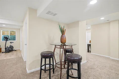 a view of a room that has a table and chairs in it
