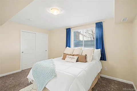 a bedroom with a large bed and a window