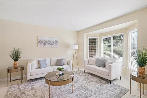 a living room with furniture potted plant and a window