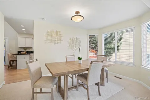 a view of a dining room with furniture and window