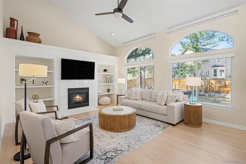 a living room with furniture a fireplace and a flat screen tv