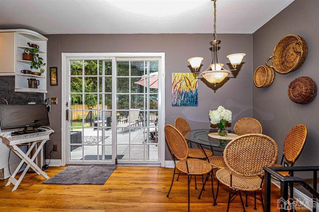 1 Butler Road Edison, NJ 08820 - Photo 17 of 25 a view of a dining room with furniture a chandelier and wooden floor