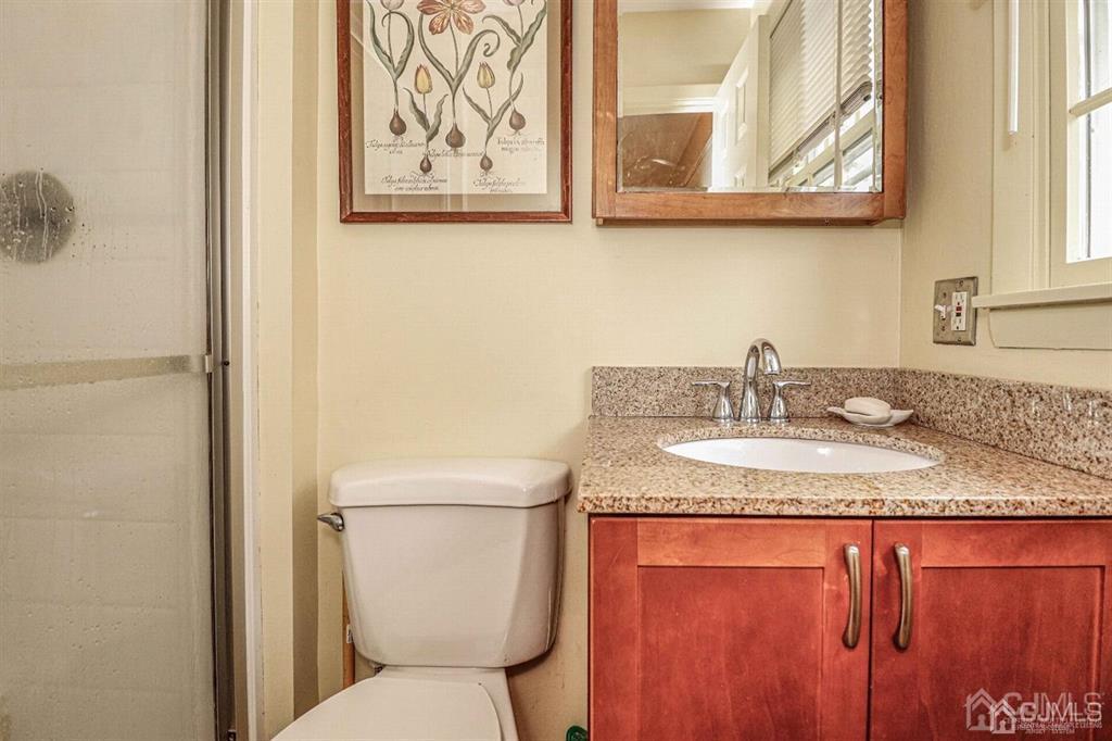 1 Butler Road Edison, NJ 08820 - Photo 20 of 25 a bathroom with a granite countertop sink and a toilet