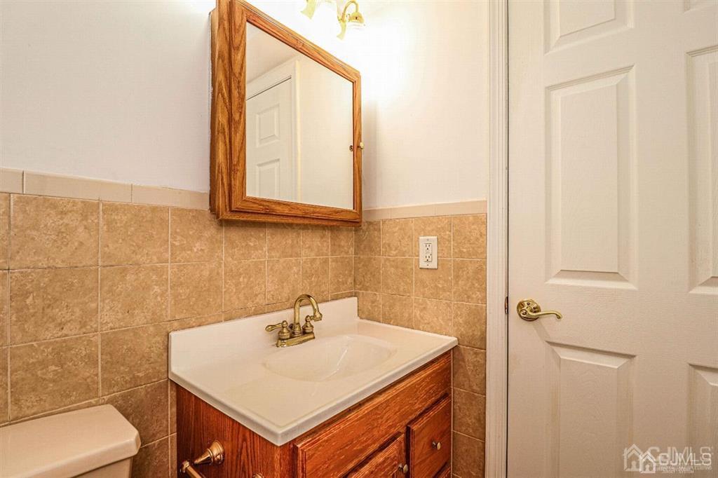 1 Butler Road Edison, NJ 08820 - Photo 7 of 25 a bathroom with a sink a toilet and a mirror